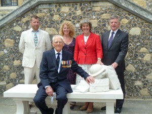 With me by the new memorial are: Simon Smith the sculptor (in cream suit) is pictured here with Fiona Whitehouse, volunteer on the project, Colin Cook ,a Winchester blue badge guide and Mr Vickers-who was born in one of the camp huts in 1920.